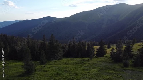 Drone View of Mountain Peaks at Dusk with Golden Sunset Light