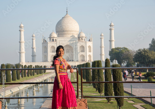 Young girl tourist in front of Taj Mahal in Agra, India . concept of culture, tourism.