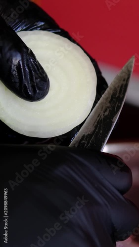 to cut onion into rings. black chef gloves
