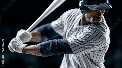 Close up of a professional baseball player in a striped uniform holding a bat and ready to swing.
