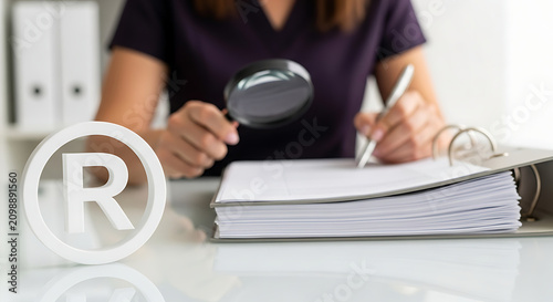 Professional checking trademark registration. Lawyer reviewing legal documents for copyright.