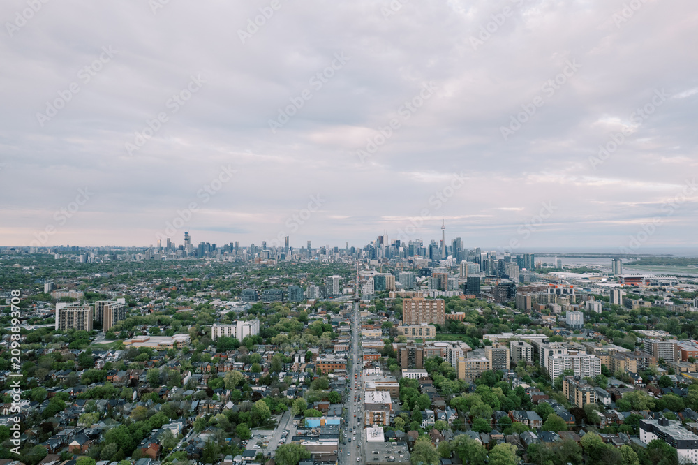 Naklejka premium Toronto city skyline with CN Tower under cloudy sky