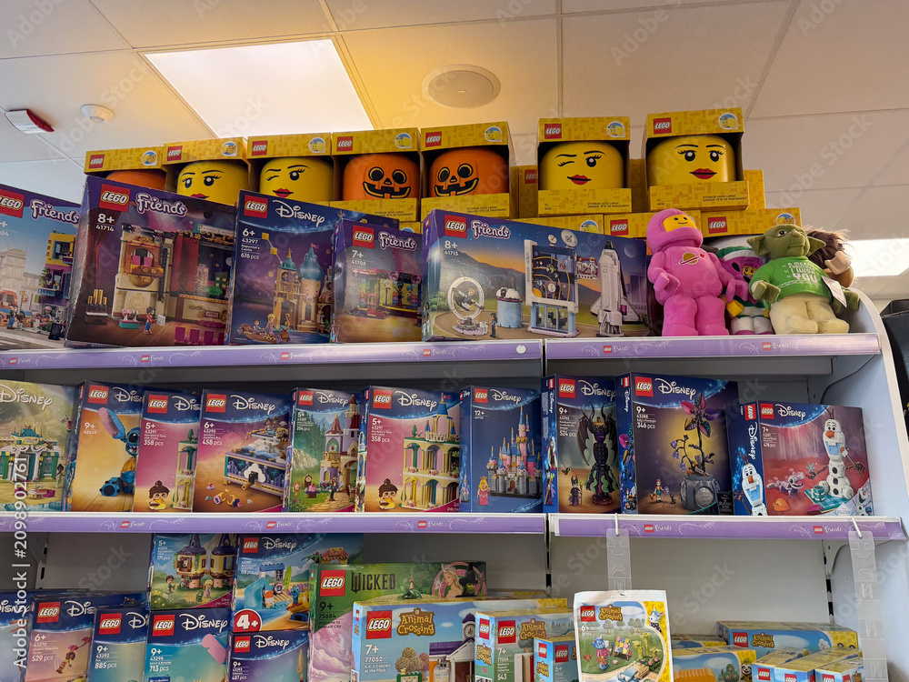 Obraz premium Assorted lego toy boxes and plush figures displayed on a store shelf in a toy shop