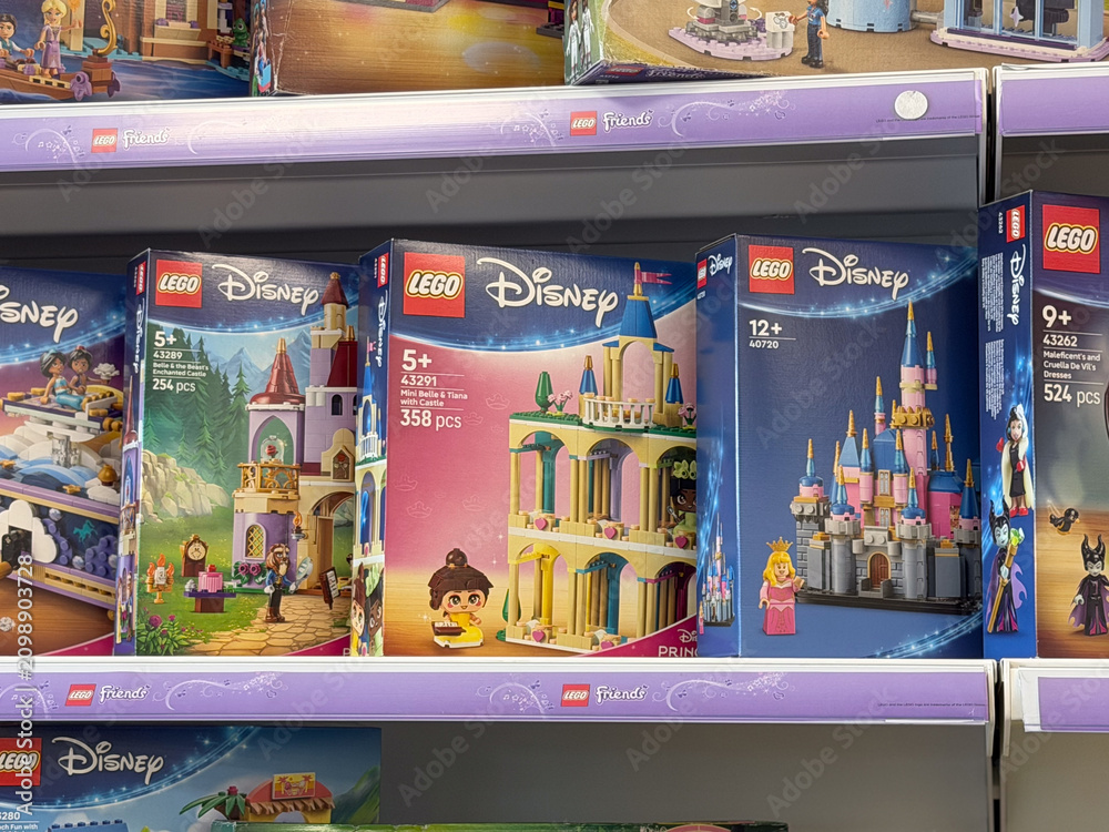 Fototapeta premium Colorful lego disney princess toy boxes displayed on a retail store shelf