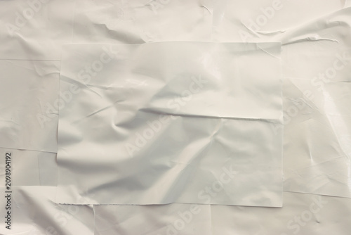 Background of white textured paper with crumples. Poster or sticker with pattern