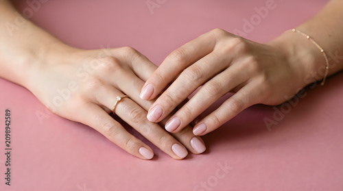 Hands holding each other with wedding ring