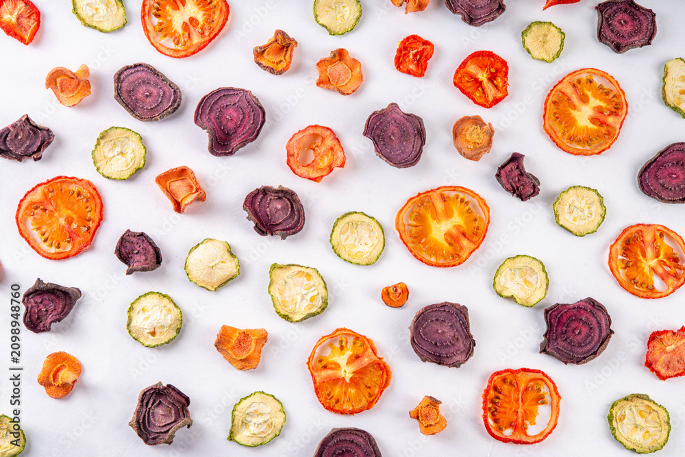 Fototapeta premium Healthy alternative for traditional potato chips, snack air fried vegetables chips, raw organic dehydrated veggies - beets, carrots, zucchini, kale, tomatoes,