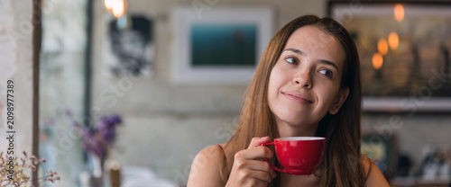Quadro su tela Banner Asian Woman drink black coffee hand holding cup at green garden cafe