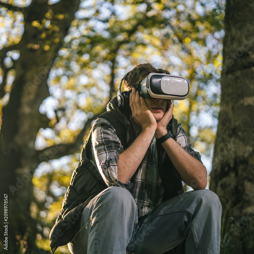 Man experiencing virtual reality outdoors in technology escape