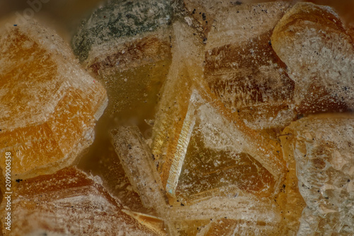 фотографія Microscope lens 5x magnification view of quintinite crystal aggregates mineral t