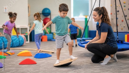 Young boy balancing on wobble board in occupational therapy