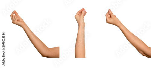 Female hand pinching thumb and index finger together. Delicate gesture as if holding something thin