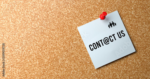 Contact Us Message on White Sticky Note Pinned to Cork Board Communication Concept