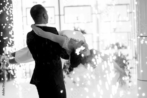 the first dance of the bride and groom inside a restaurant
