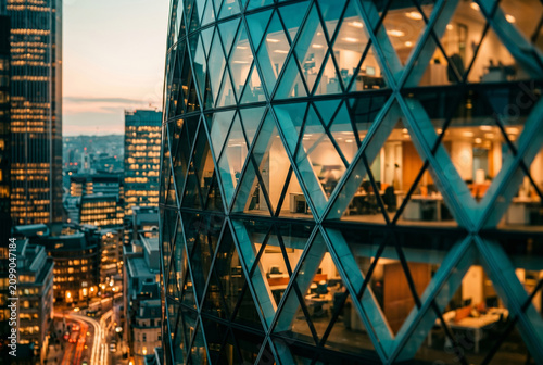 Glass facade, office tower, city skyline, dusk urban architecture with illuminated interior