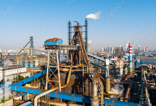 Wuhan steel plant, featuring a complex geometry of massive blast furnaces and intricate pipelines. It reflects China's industry and economy evolution, while driving a sustainable green transition..	