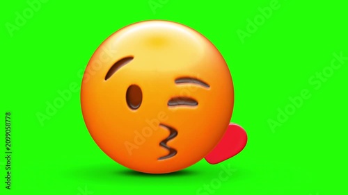 3D orange emoji face blowing a kiss with a small red heart icon, featuring a winking eye, puckered lips 4k stock animation video on a green screen for chroma key background in video editing.