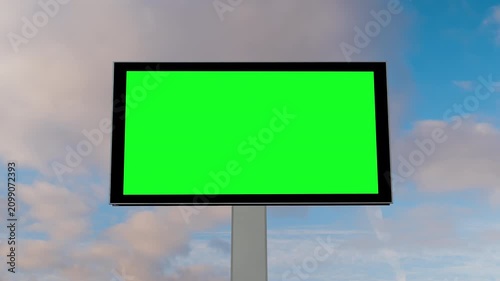 Timelapse: front view - blank green billboard or large display and moving white clouds against blue sky. Time lapse, advertising, green screen, consumerism, mock up, copy space and chroma key concept