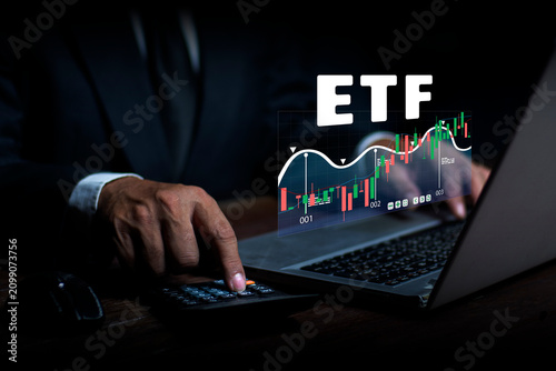 ETF Exchange-traded fund stock market business finance investment concept. Businessman using calculators analyzes Exchange Trade Asset Technology.