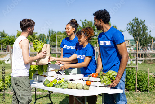 Volunteers distributing fresh produce at community garden market