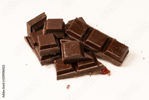 A chocolate bar with dried berries isolated on a white background.