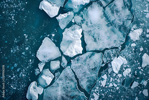 Aerial view of cracked ice floes on turquoise water surface