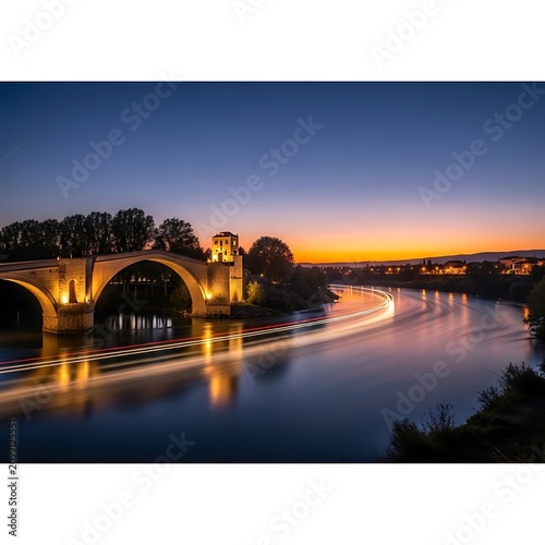 Scenic Night View of Historic Bridge Over River.