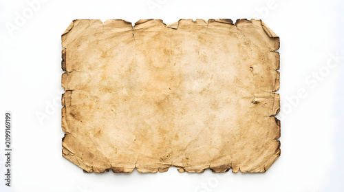 Aged parchment with torn edges lying on a surface