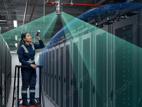 Technician Inspecting Server Room Suppression Nozzle