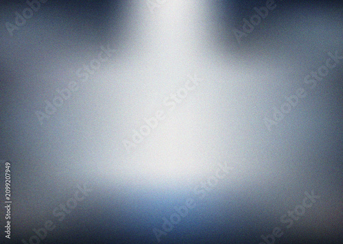Dramatic central spotlight effect with grainy texture on a dark grey and blue abstract surface