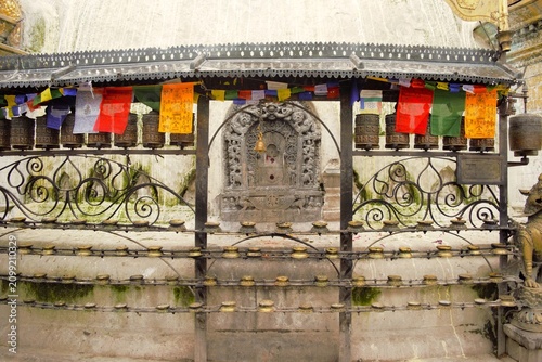 Fotografie Traditional Buddhist Prayer Wheels at Swayambhunath Temple in Kathmandu, Nepal