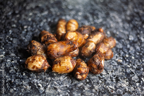 Boiled taro roots on black marble countertop