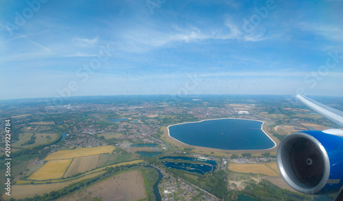 Water Storage Landmark: High-Altitude Aerial View of Queen Mother Reservoir, Berkshire Countryside, and Jet Engine from an Airplane Window, Near Heathrow Airport, England