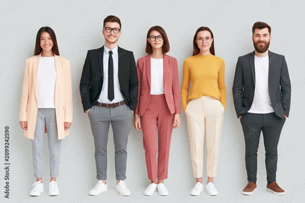 Obraz premium Professional diverse team of five standing in smart casual outfits for corporate banner and business team portrait background