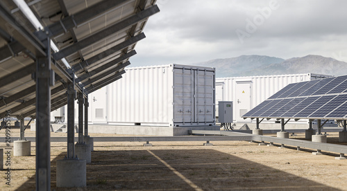 Fotografie Modern solar energy farm with battery storage containers and photovoltaic panels