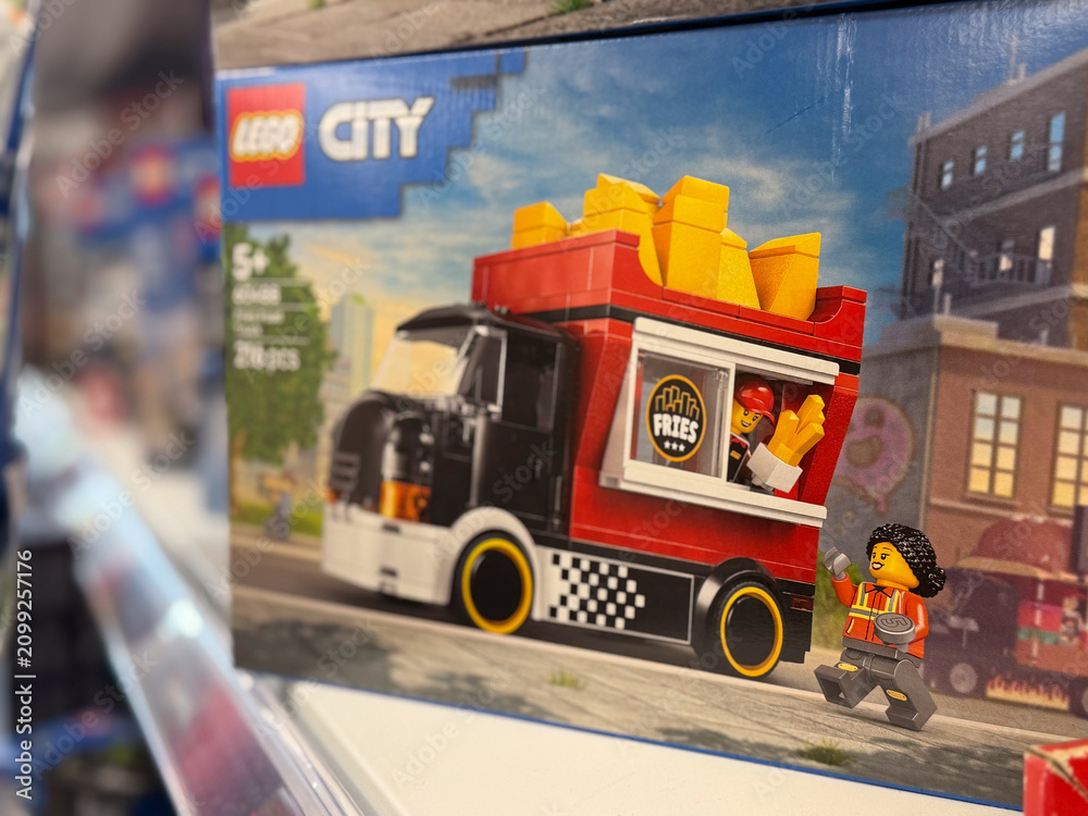 Obraz premium Lego city toy box showing a fries food truck and minifigure on a store shelf