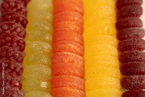 Canvastavla macro closeup of colorful sugarcoated gumdrops and jelly candies arranged in nea
