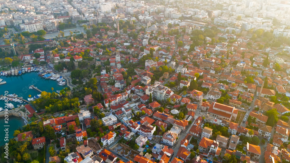 Fototapeta premium Antalya, Turkey. Aerial drone view of historic Kaleici Old Town with yacht marina and Mediterranean Sea connection in morning sun.. Aerial View