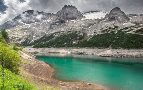 Marmolada glacier and Lake Fedaia dam with beautiful turquoise blue water und...