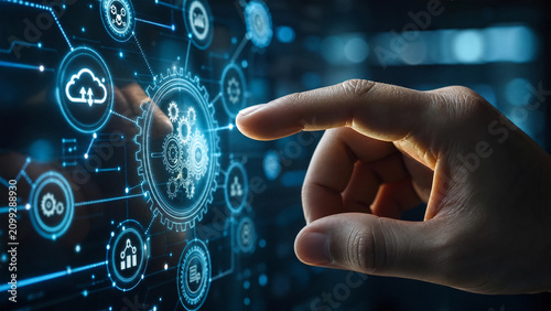 Human finger touching a futuristic digital screen displaying an interconnected network of data and process icons