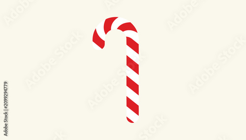 Classic red and white striped Christmas candy cane is angled diagonally on a plain off white background.
