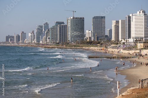 People Relaxing on the Beach with Tel Aviv Modern Skyline