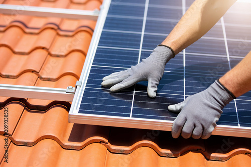 Installing solar panels on a tiled roof for renewable energy generation
