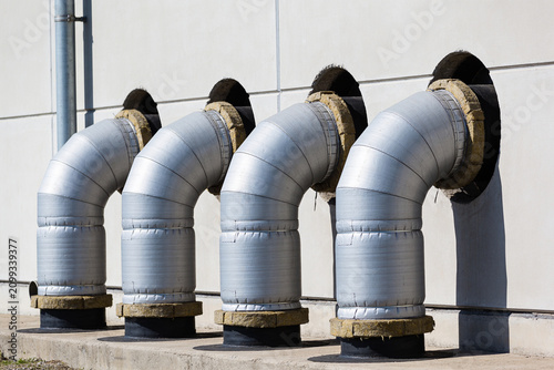 фотографія Industrial ventilation pipes exiting a building's exterior wall