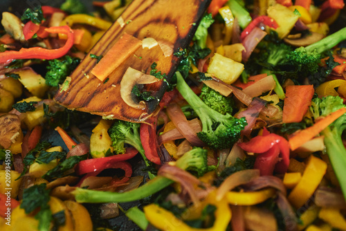 Fotografie Colourful vegetable stir-fry sizzling in a pan