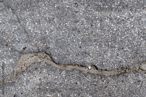 cracked asphalt paving with rough texture