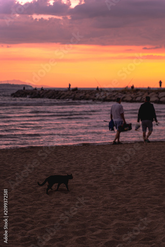 People and boats trying to fish at sunset