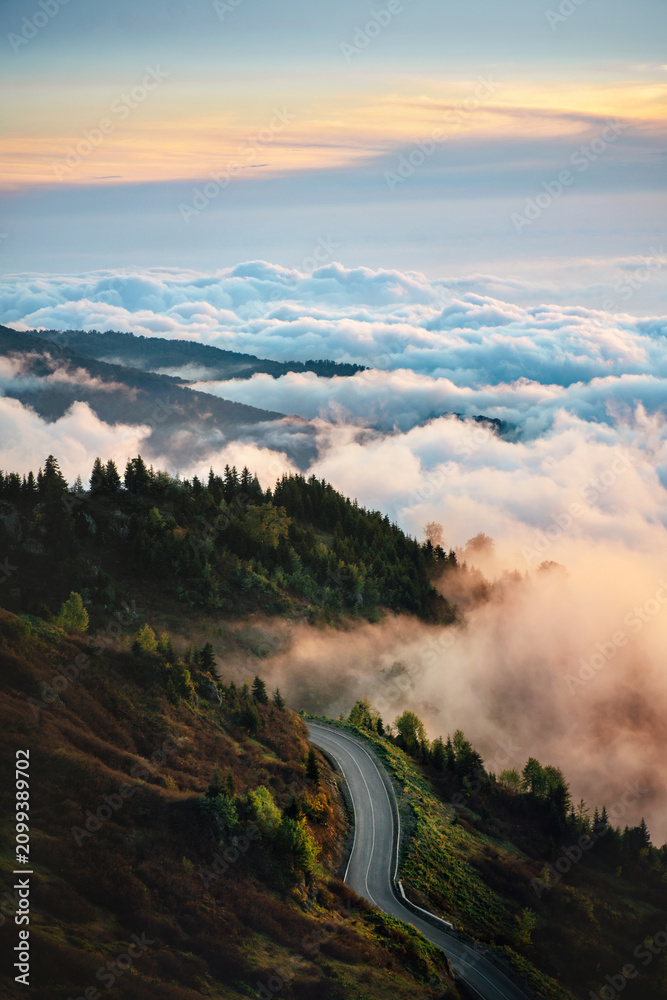 Fototapeta premium Aerial view road in Caucasus mountains and clouds in Georgia, travel beautiful destinations explore Guria nature summer season Gomis Mta sunset scenery