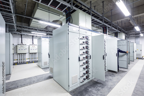 Modern electrical control room with large distribution panels and wiring systems