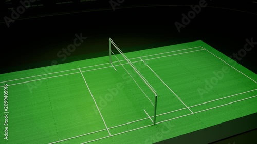Panning camera moving forward over raised green court, revealing center net posts under lights